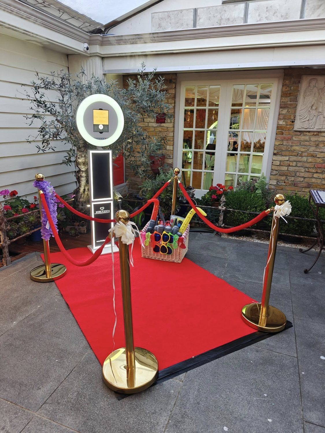 Photo booth hire with red carpet and gold barriers at an Essex wedding